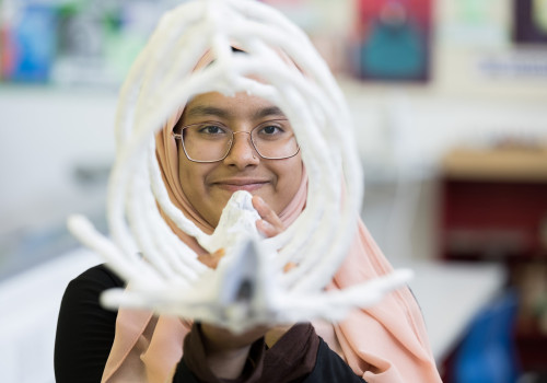 Student holding artwork