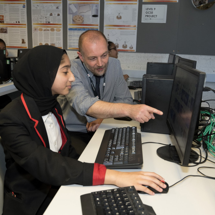 Student and teacher in computer room