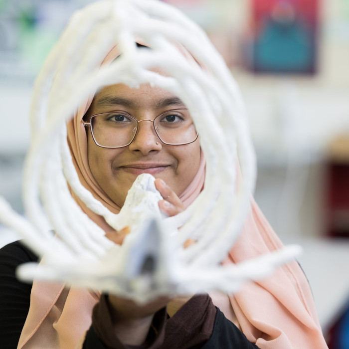 Student holding artwork